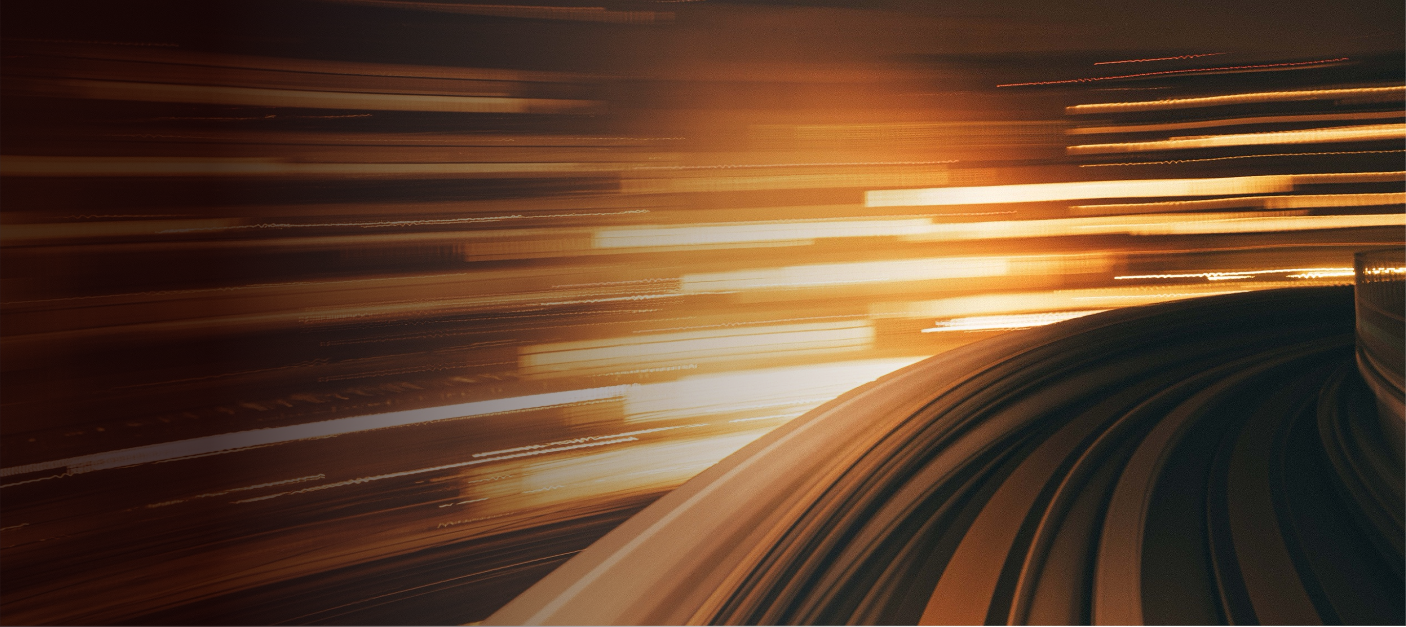 A hero banner with an abstract, high-speed view from a machine on a track, its motion illustrating forward-moving technology.