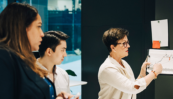 Coworkers looking at a graph trending upwards