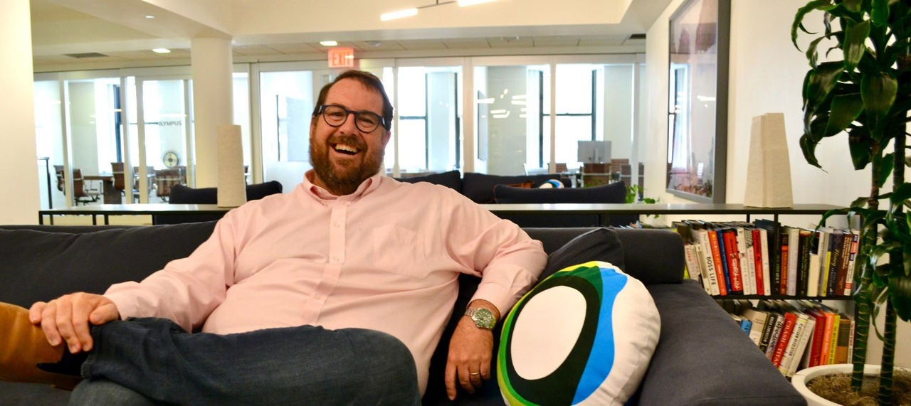 Peter Jonas, Paxos’ chief revenue officer, seated on a couch in the NYC office. 