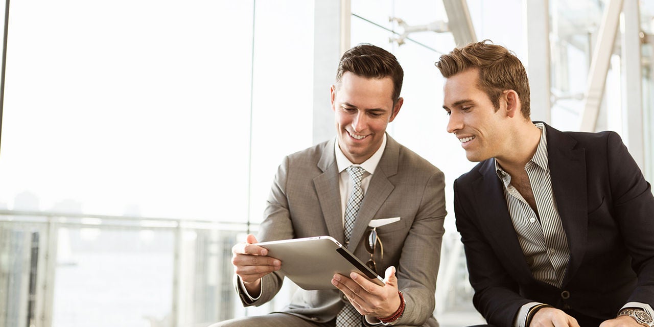 Two businessmen using a tablet