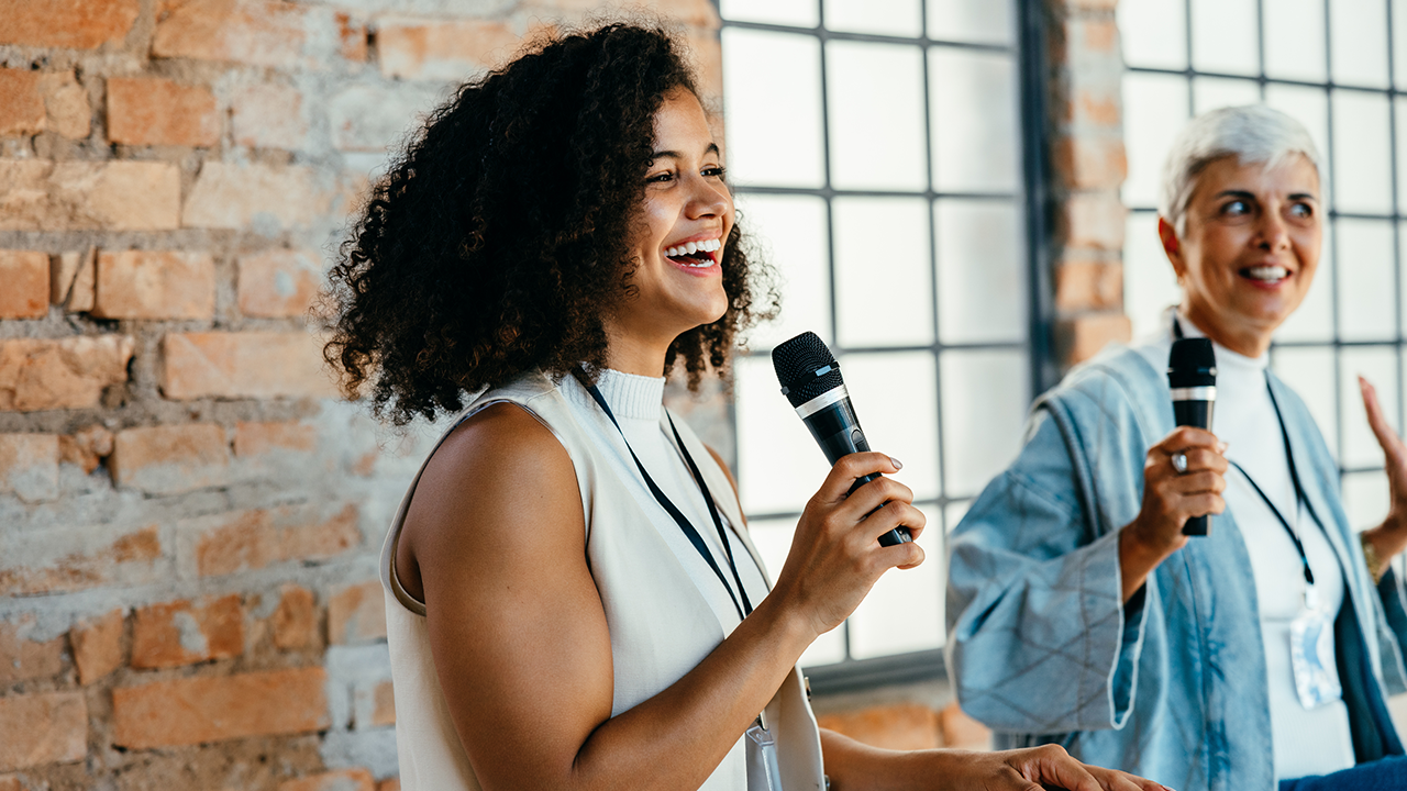 Two women singing with microphones