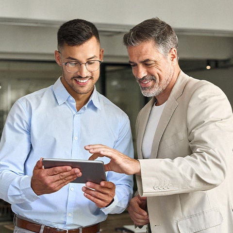 Man smiling holding his phone