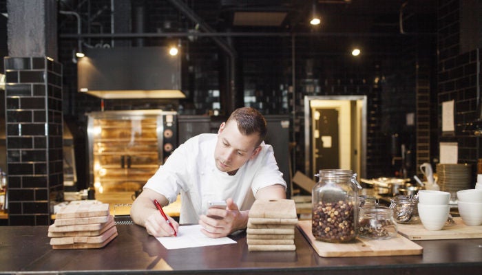 Chef writing on his desk