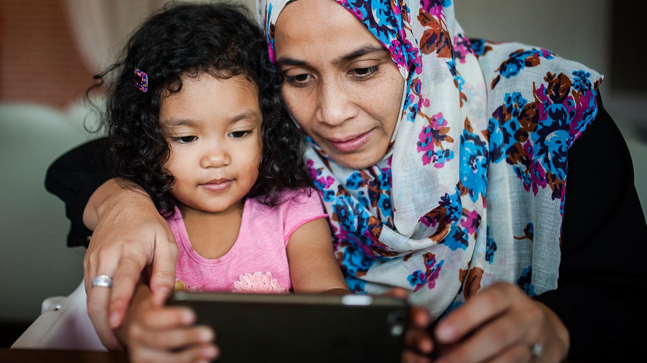 grandmother and child using mobile phone