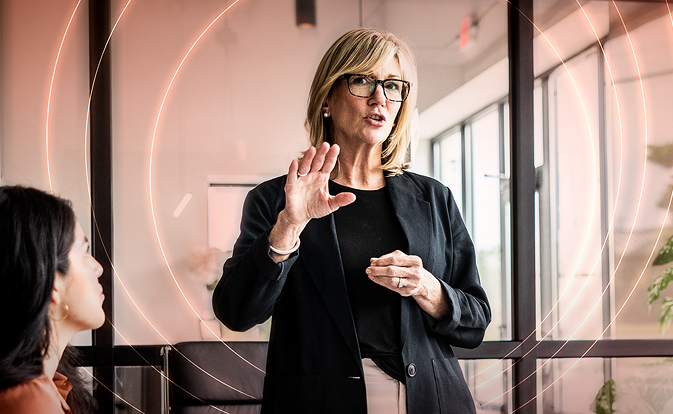 A lady in black blazer presenting in front of team