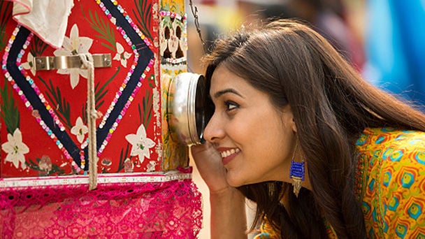 Woman in street market looking into decorative box