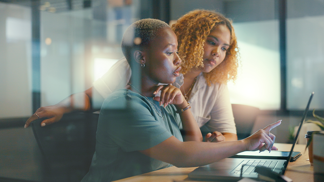 Two women looking at computer screen