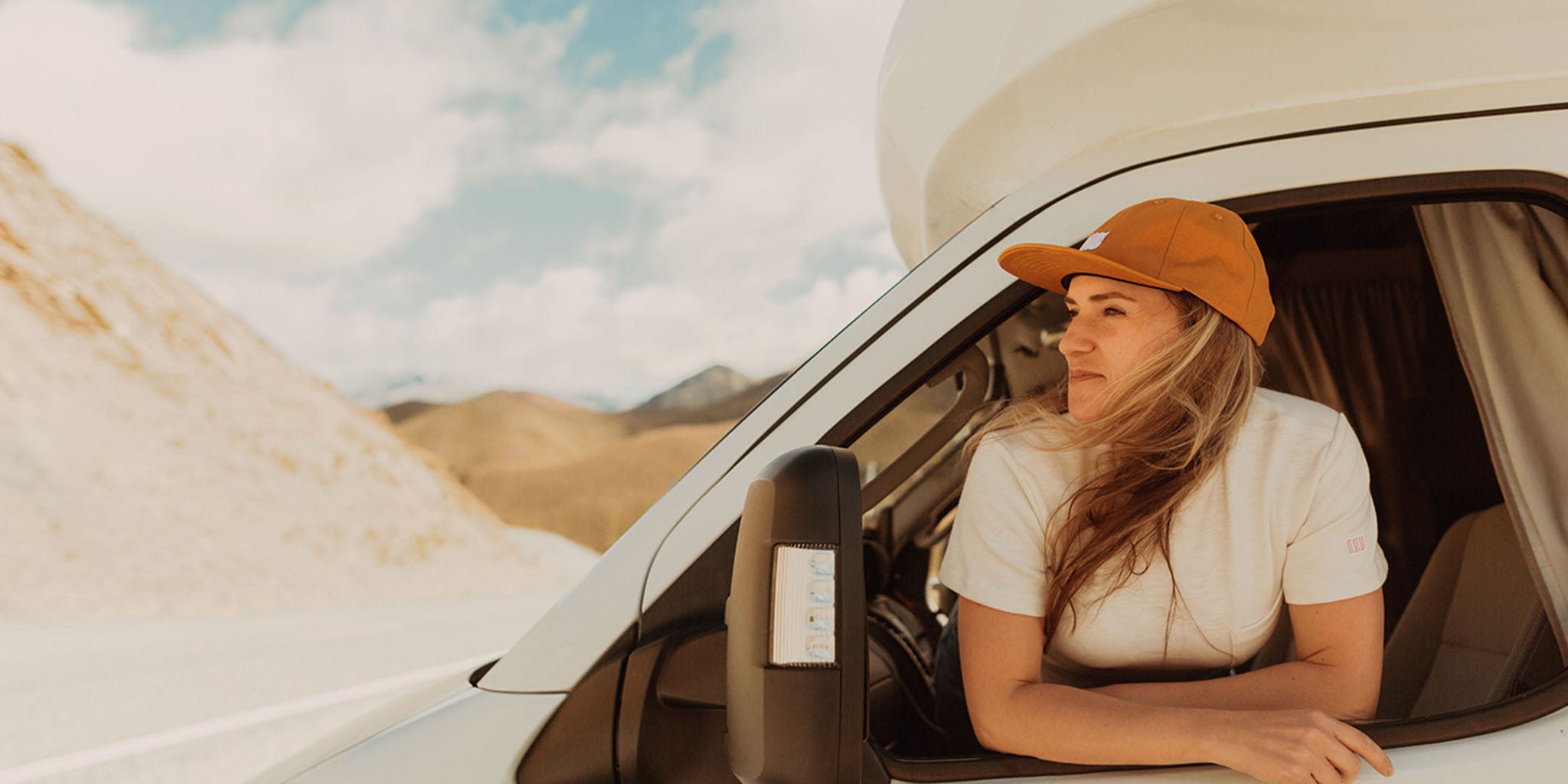Young woman in a hat in the desert