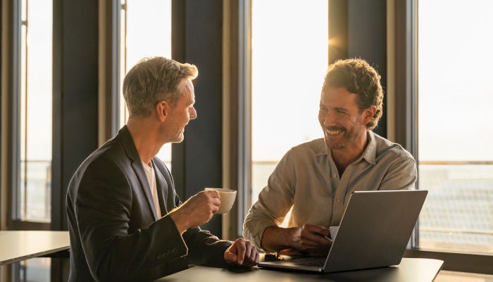 Two men laughing in the office