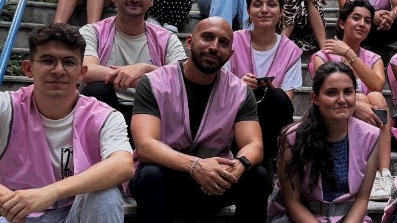 Baris Ercan and his Mastercard colleagues sit on a step after a volunteer effort. 