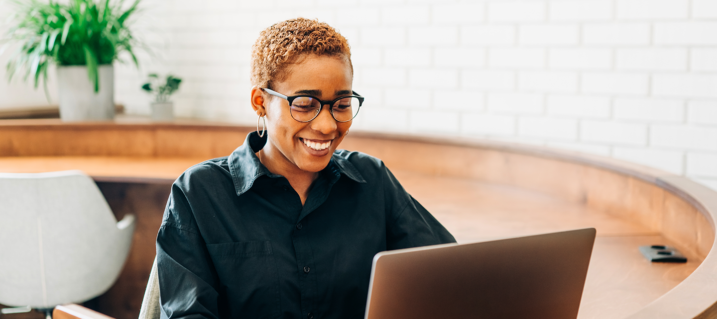 Woman on her computer reviewing best practices