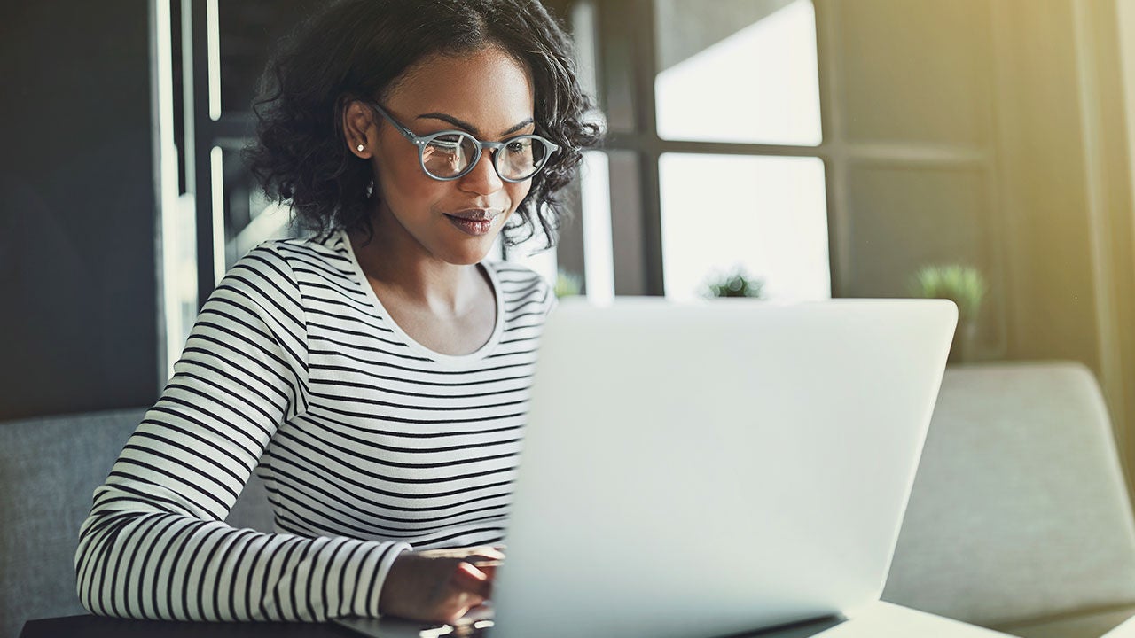Woman working on a laptop.