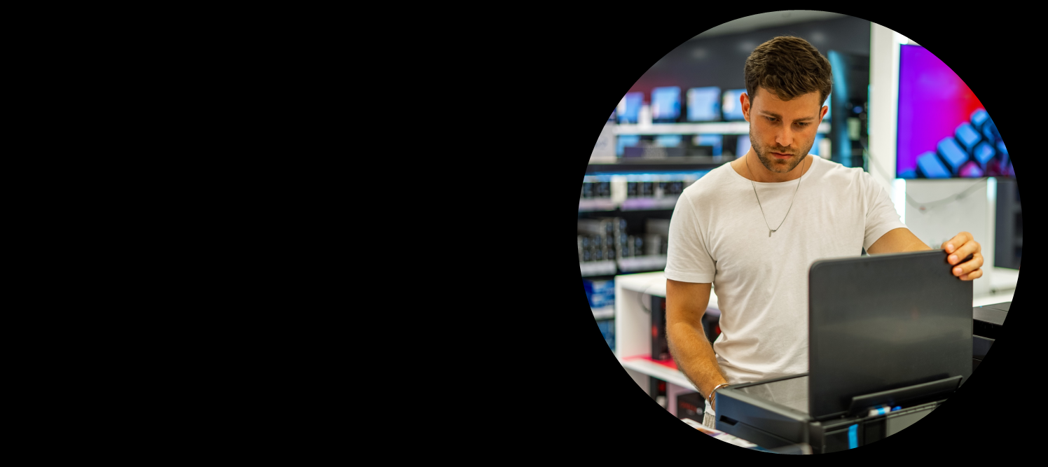Man in computer store looking at laptop