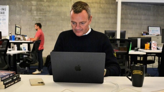 Christopher Alberg look at a laptop in the Recorded Future offices. 