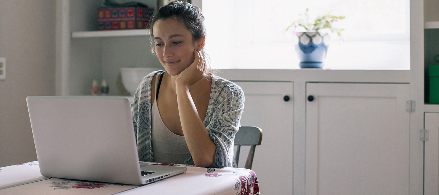 Woman looking at her computer in a table