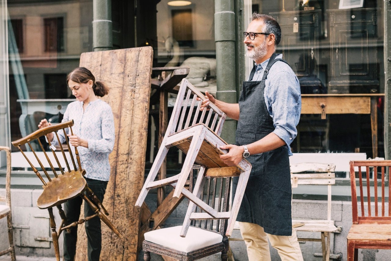 Business owners moving chairs