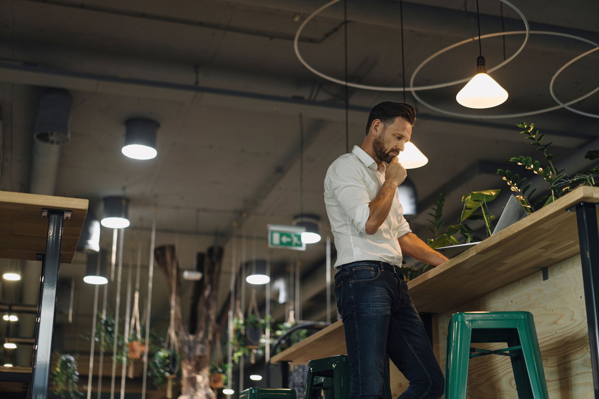 Man in office pondering