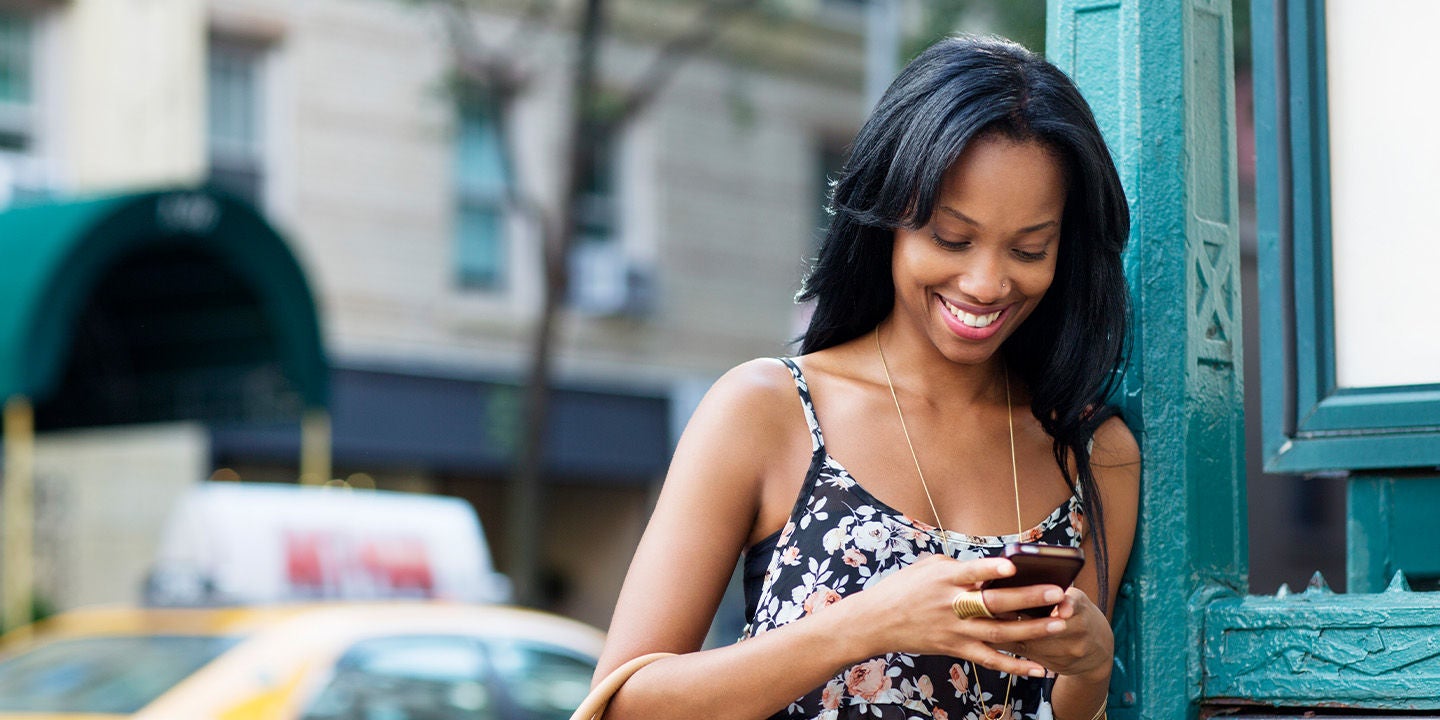 Woman using her phone in the street