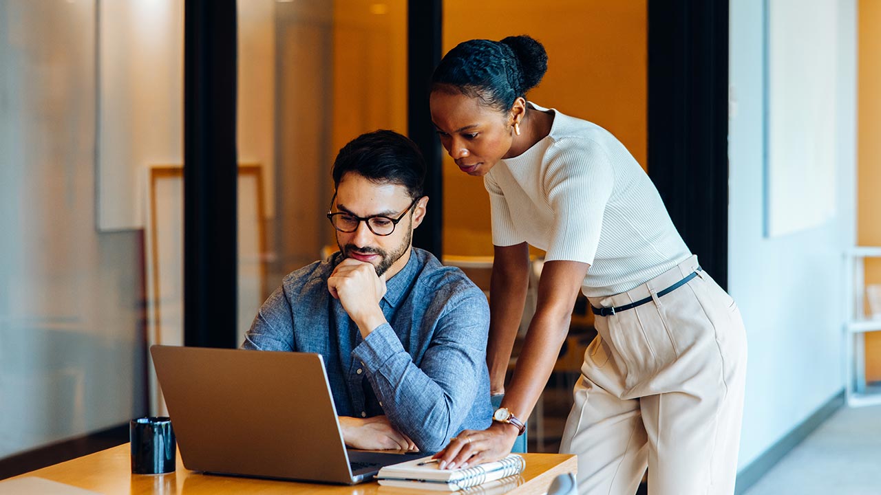 Serious colleagues collaborating in office.