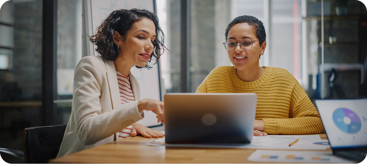 Two women looking at a laptop