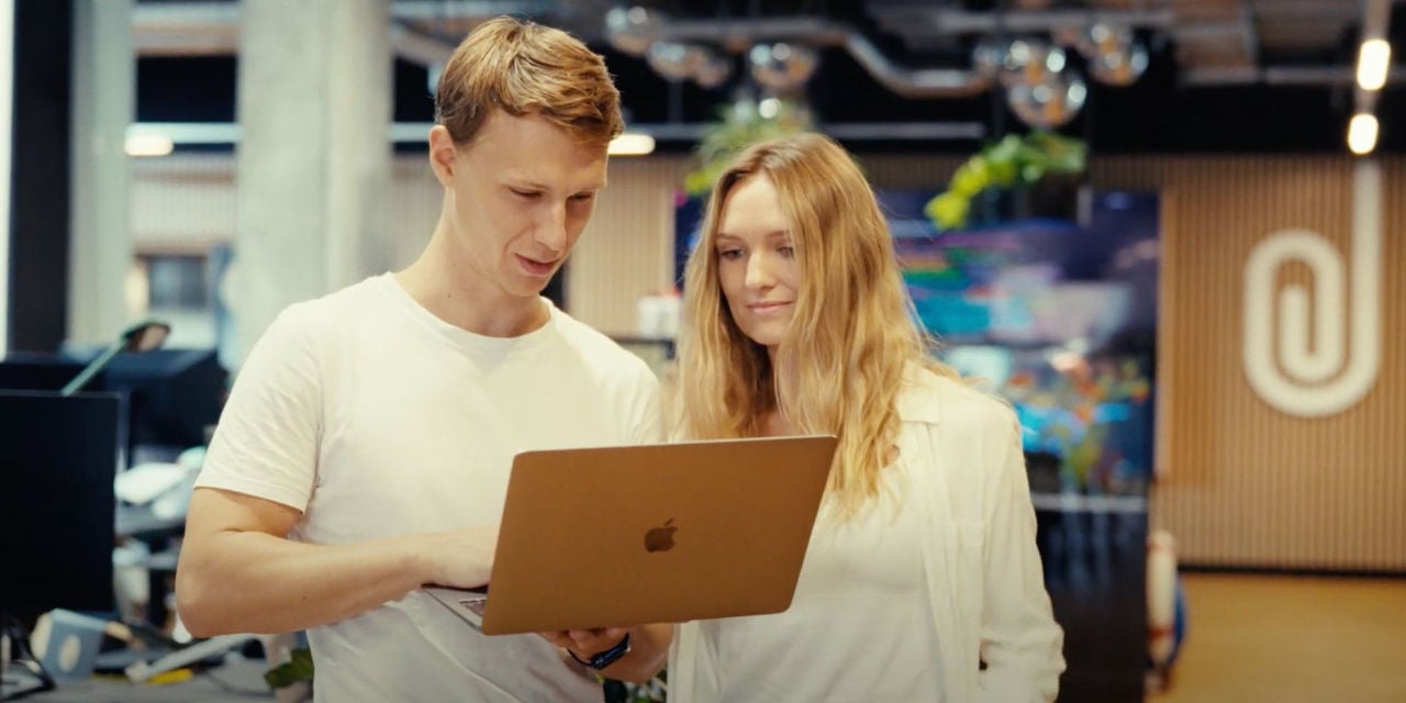 Young man and woman at work using a laptop