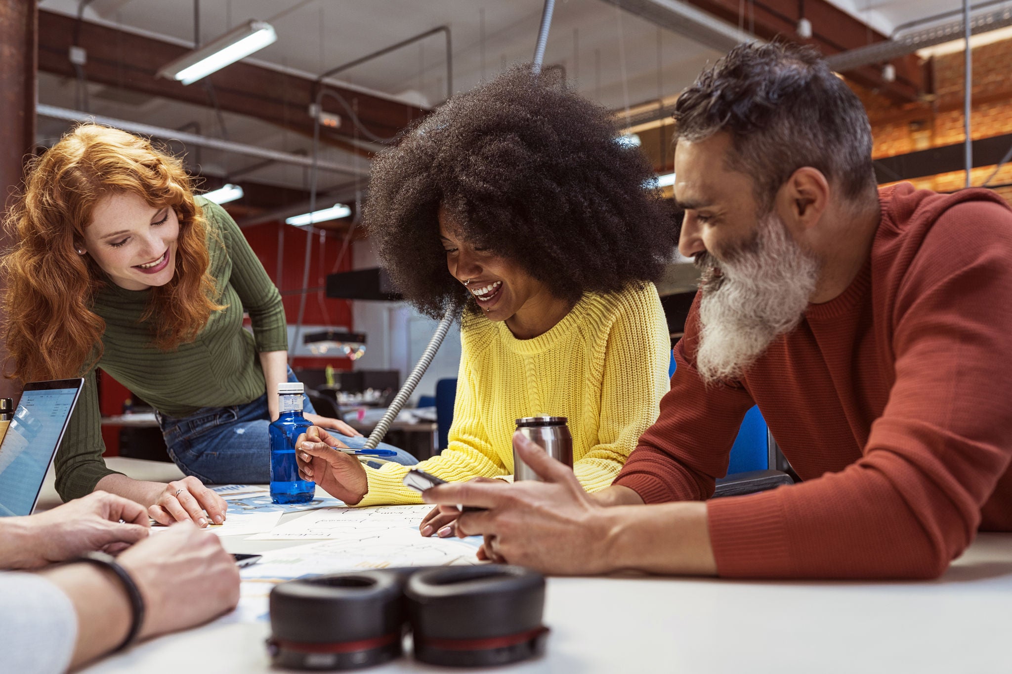 Group of young multi-racial business people working and communicating together in creative office