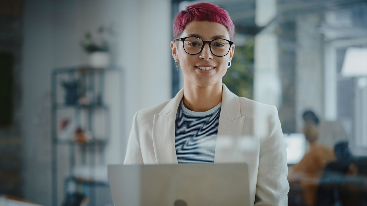 Specialist standing with laptop.