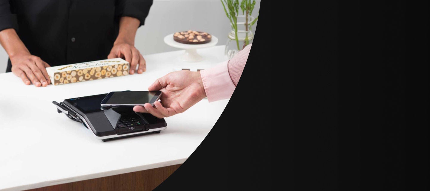 אדם משלם באמצעות טלפון נייד