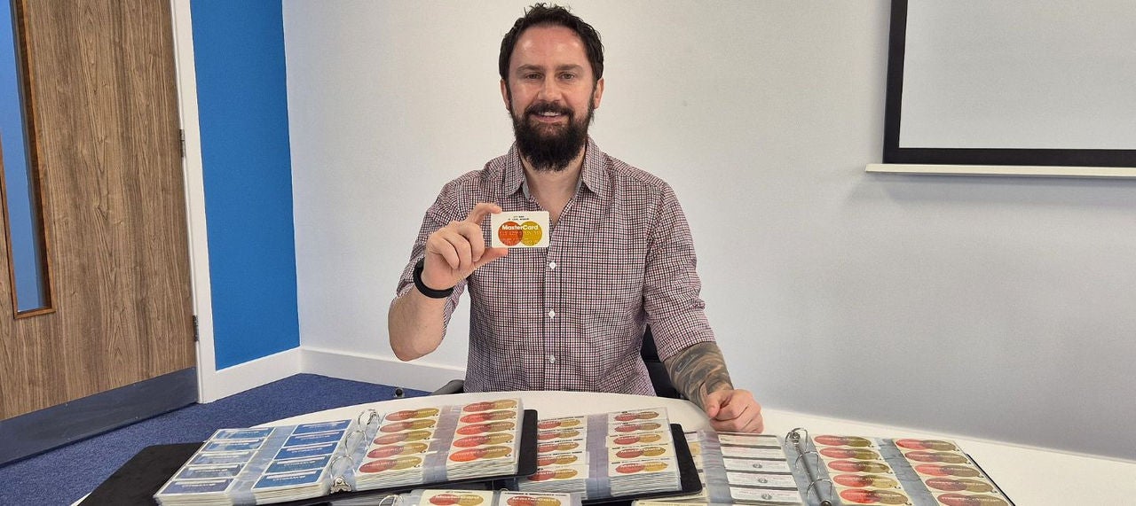 Rich Hudson holds a Master Charge credit card, one of my in his collection. 