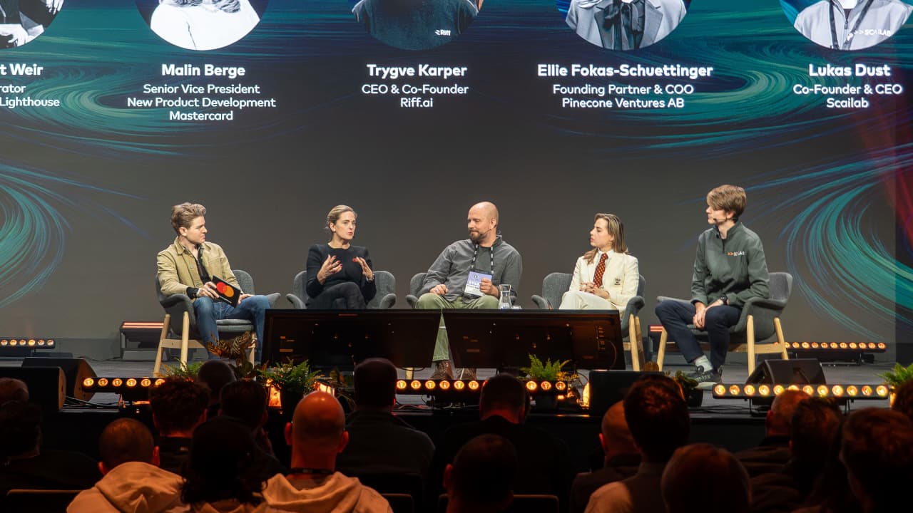 people having panel discussion on a stage