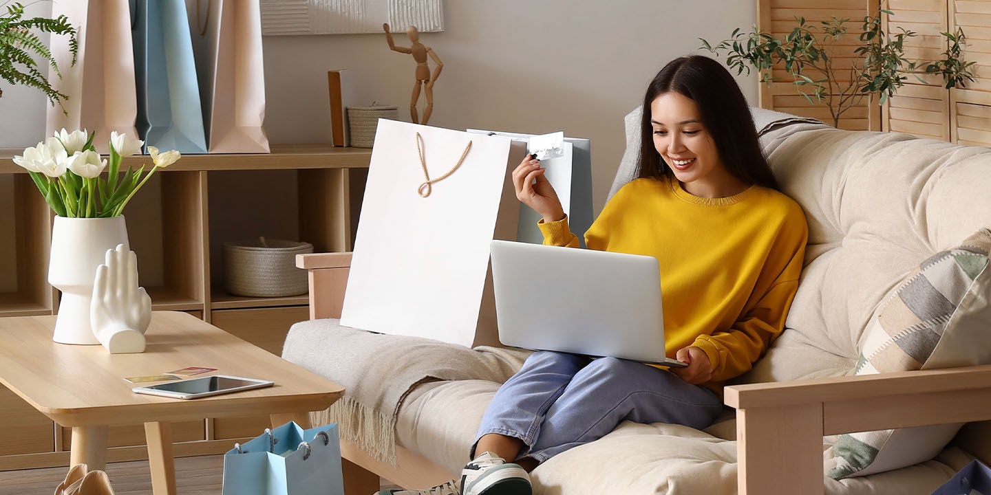 Woman in a yellow sweater shopping online
