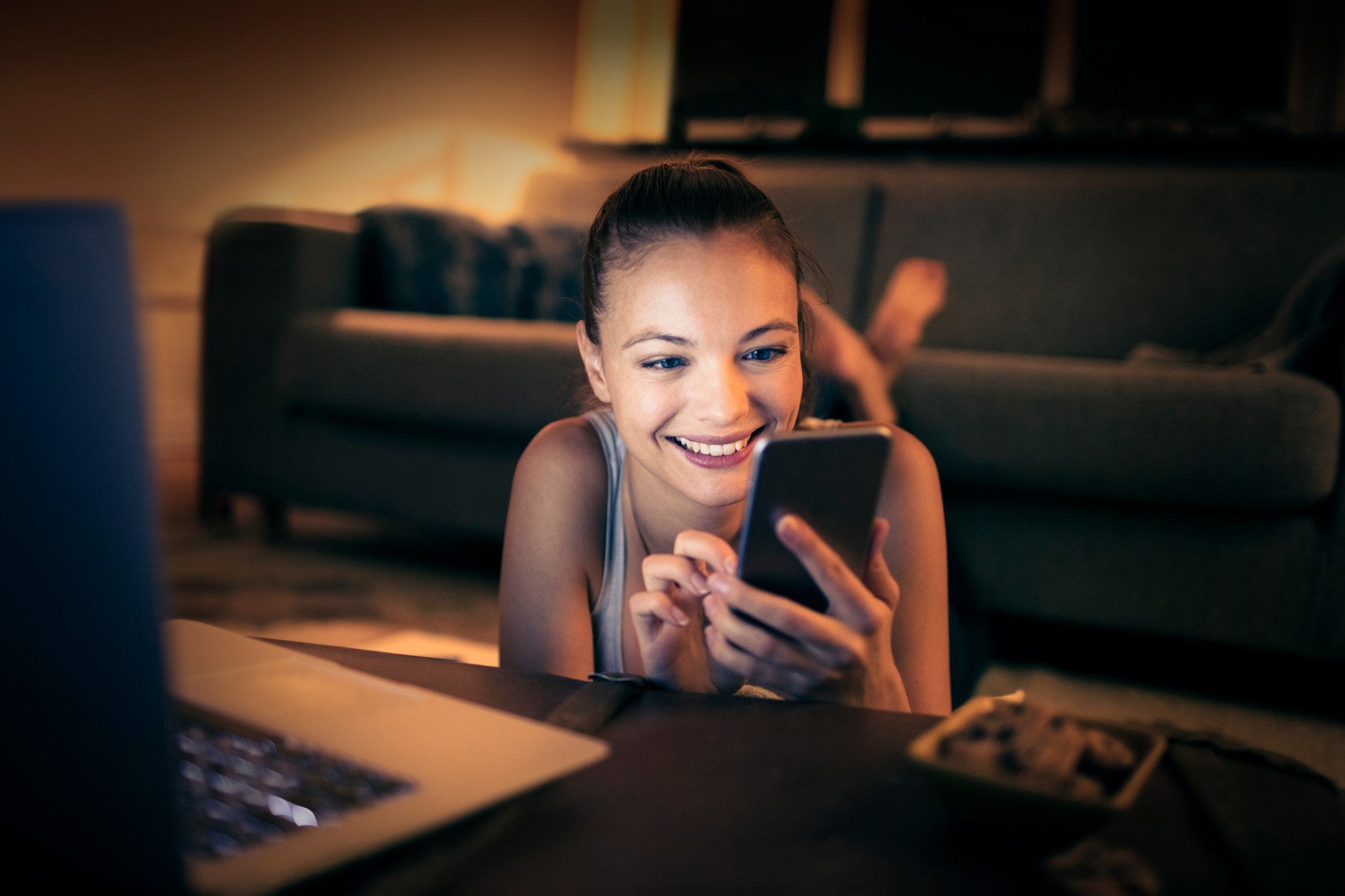 Woman smiling while shopping and looking at her phone.