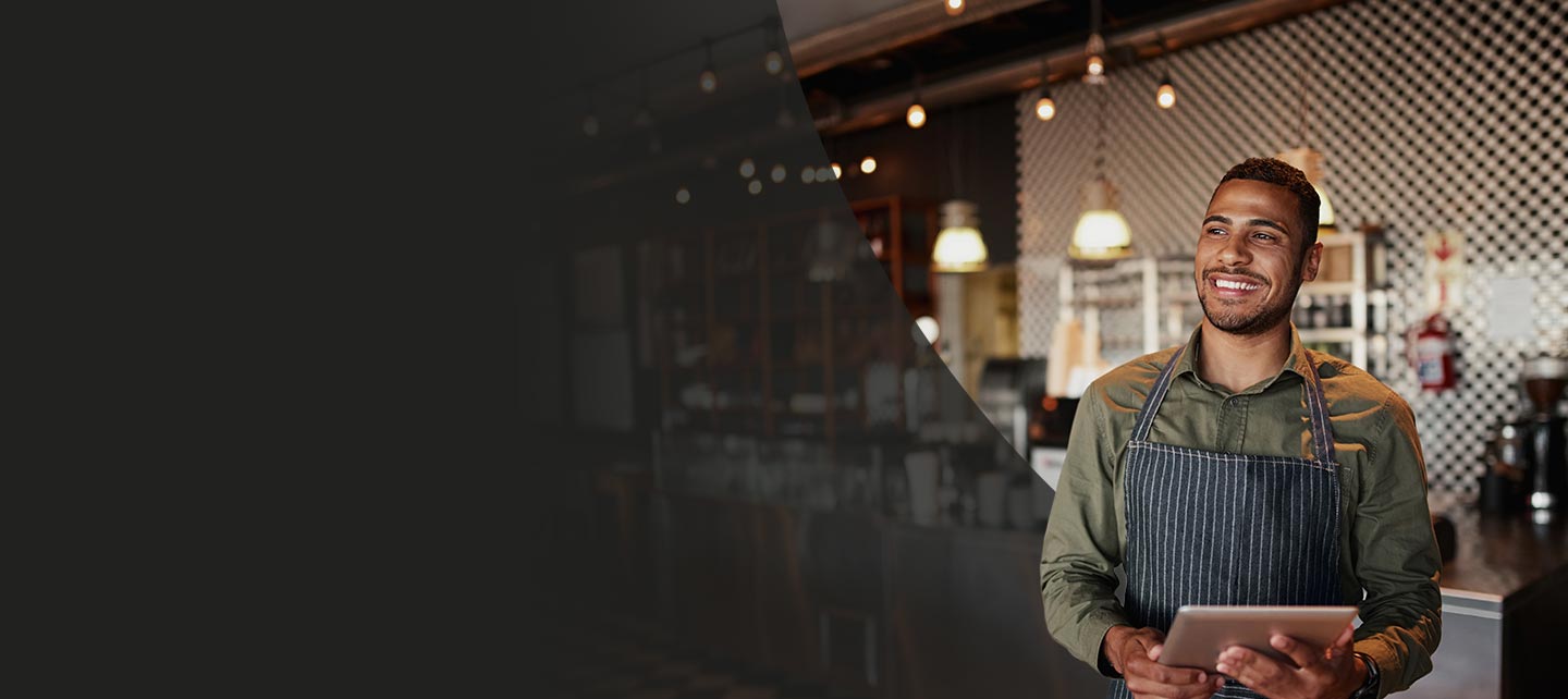 Cafe owner with tablet in cafe.