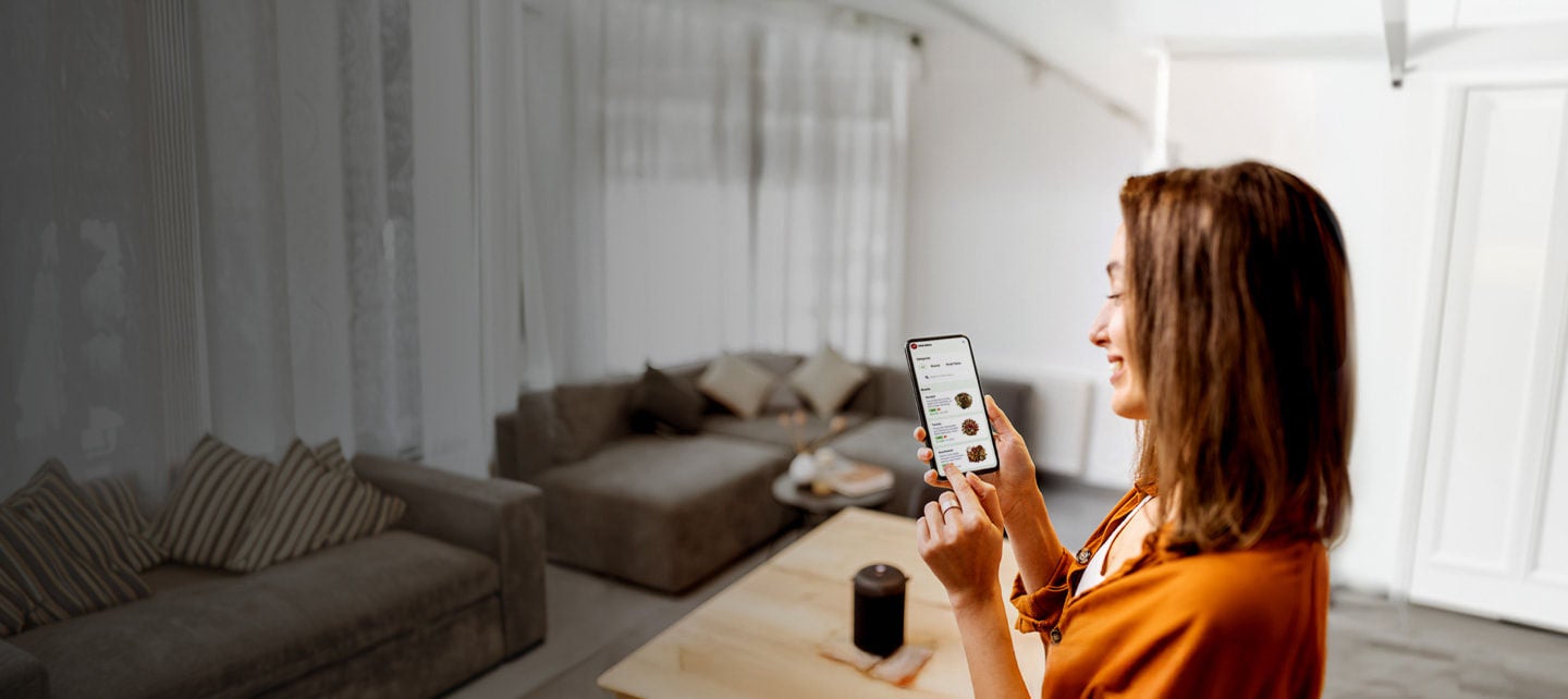 woman using smartphone at home