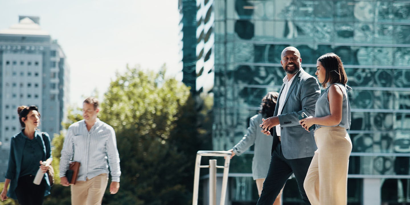 People walking by an office building
