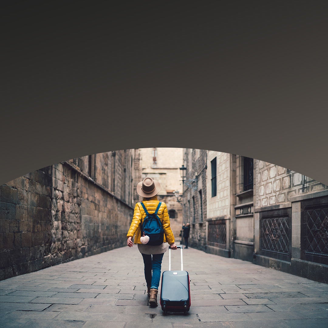 Tourist with luggage walking in street.