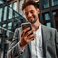 Portrait of business professional smiling using phone.
