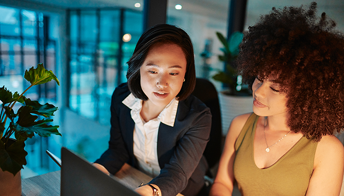 Two women coworkers brainstorming