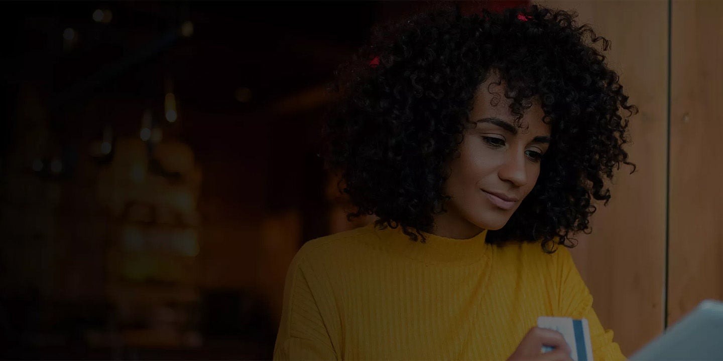 Woman looking at smartphone on city street