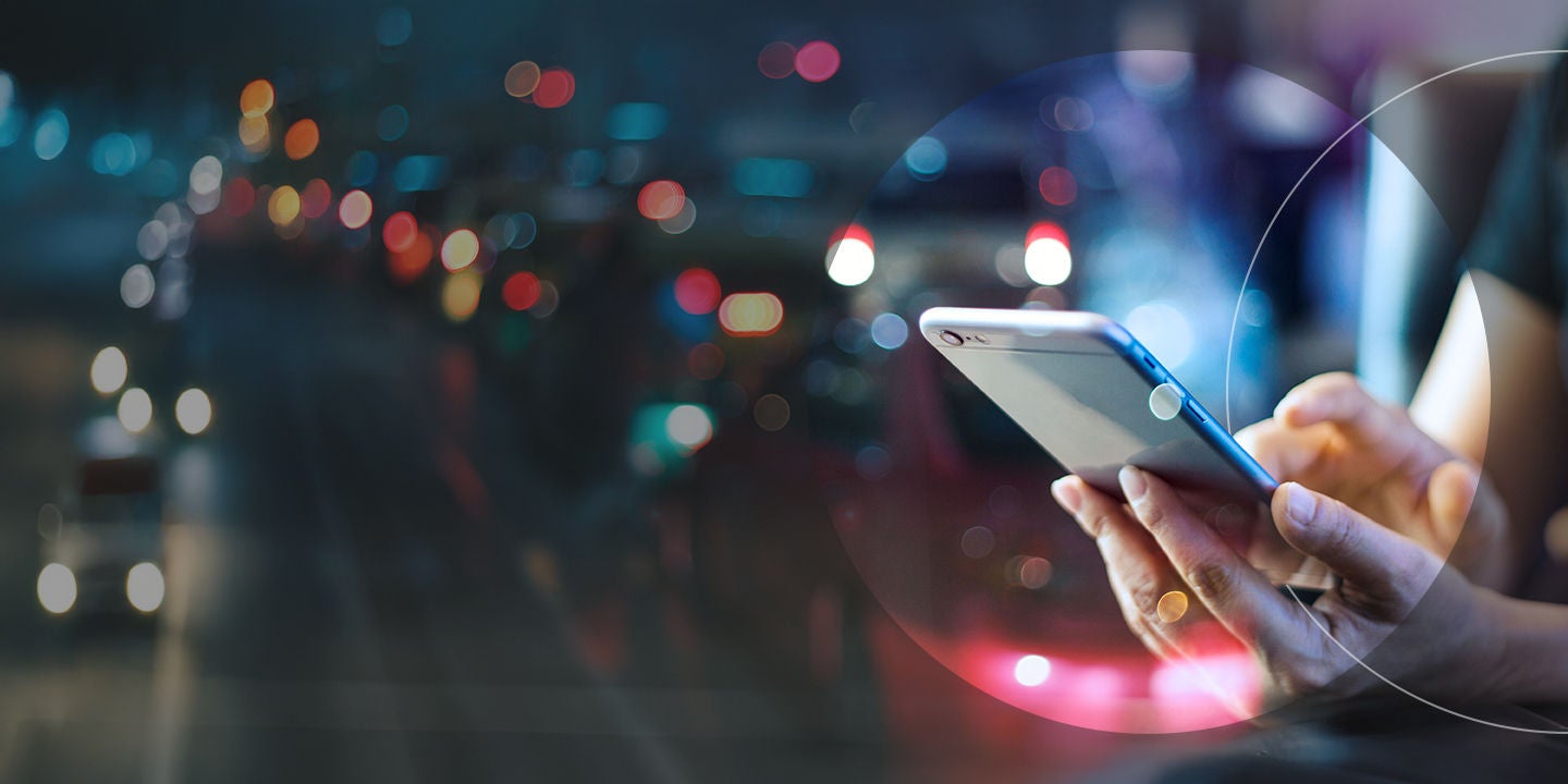 close up of a man using phone at night.