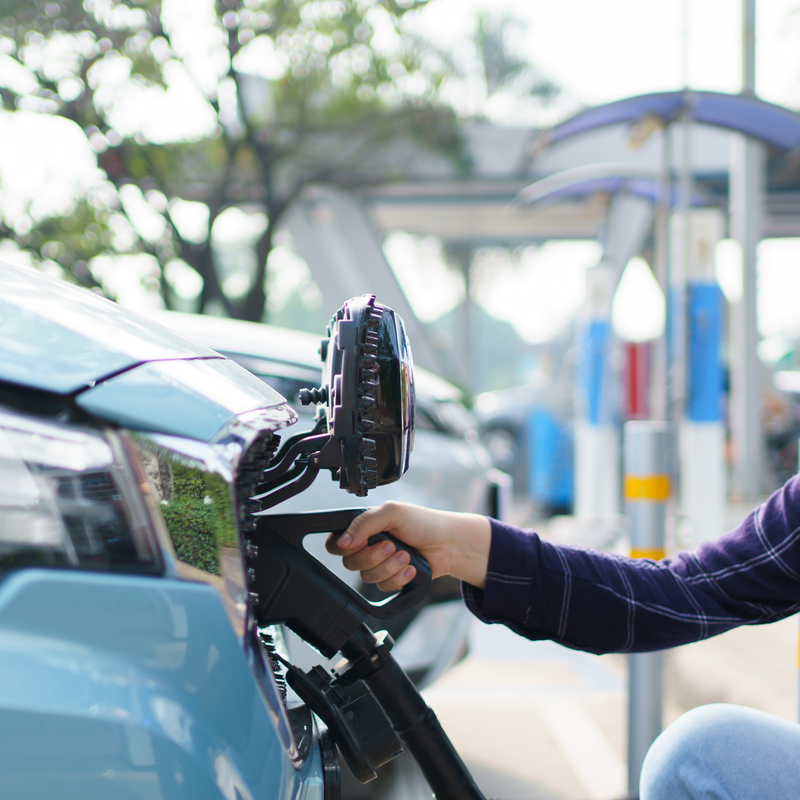 A person charging an EV