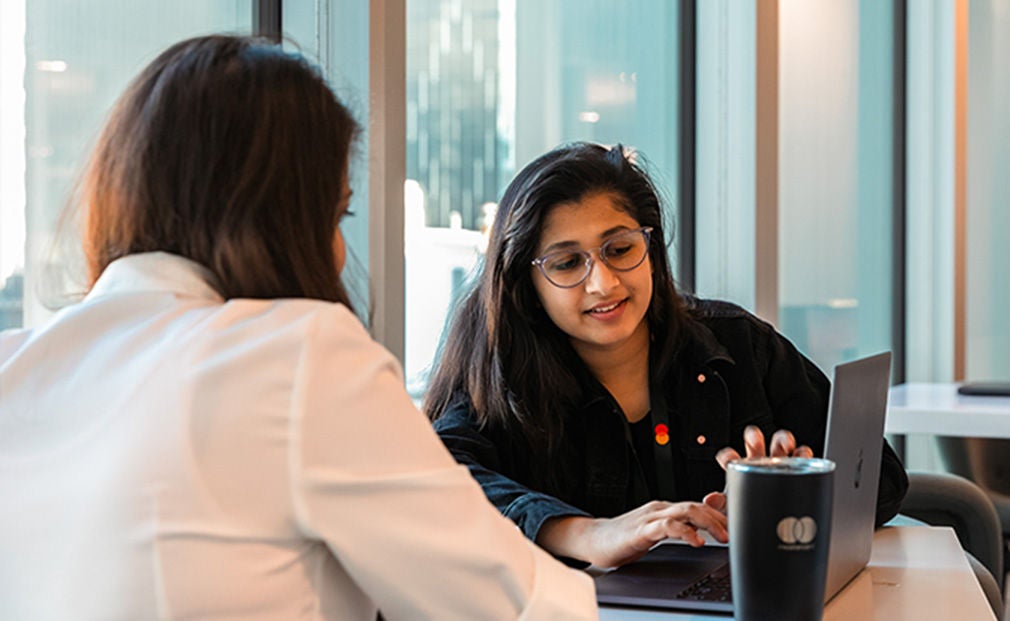 Happy woman using phone in office