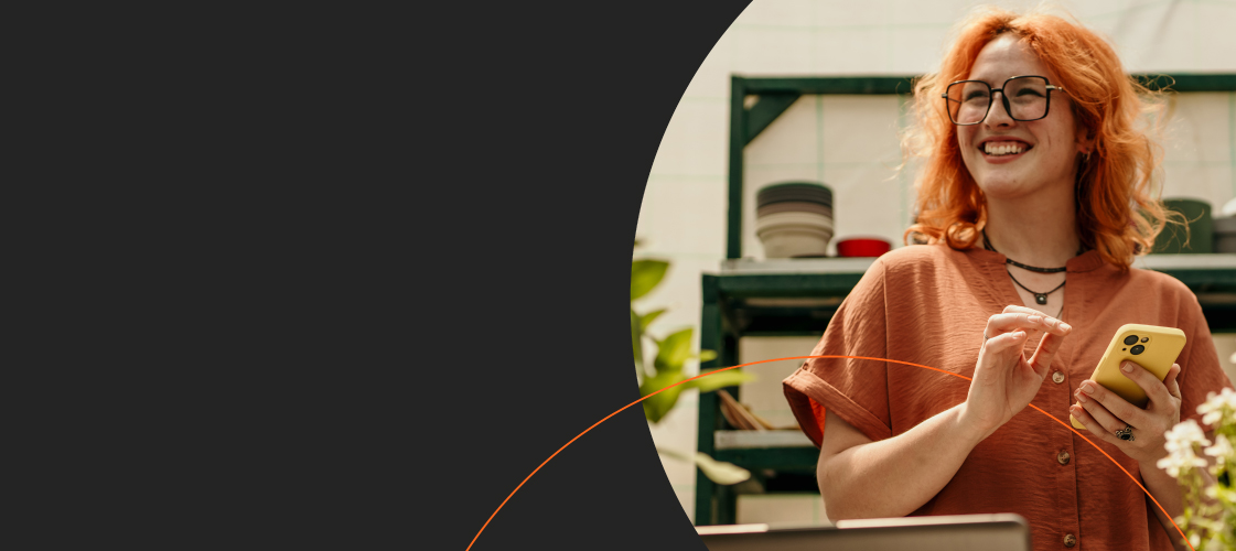 Woman holding phone smiling