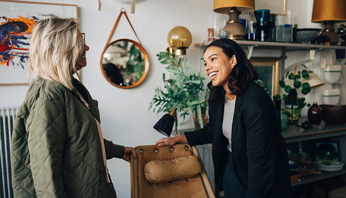 Woman sales associate selling to a customer mobile