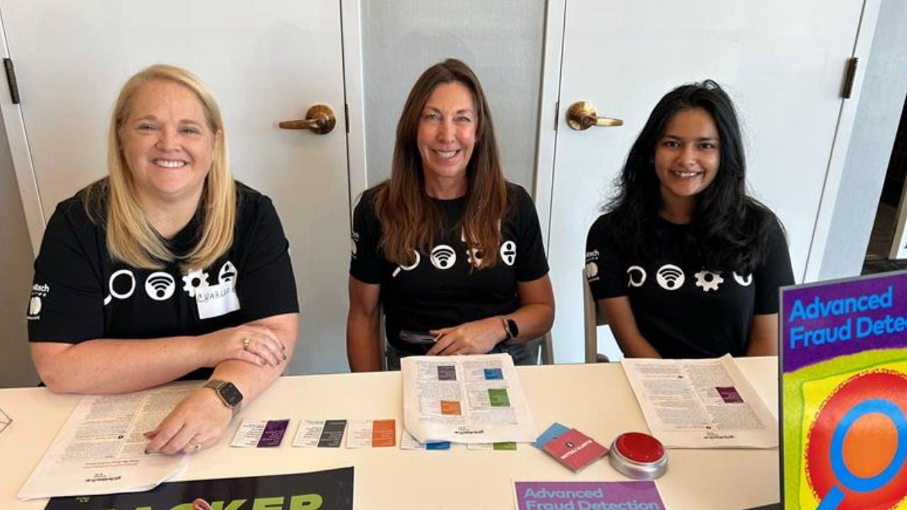 Mishwa Bhavsar with other Kids4Tech volunteers staffing a table at an event.