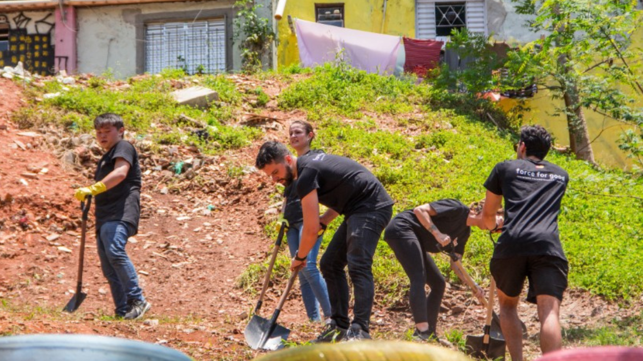 Mastercard volunteers dig up a hillside in a Sao Paulo favela. 