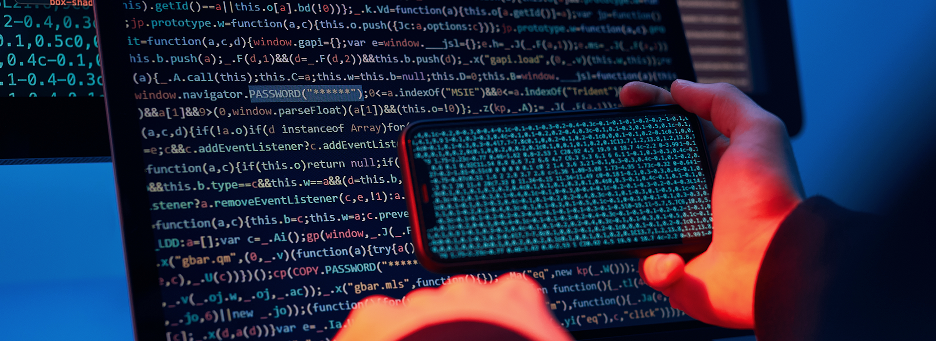 コンピュータ画面と携帯電話に表示されるプログラミングコード