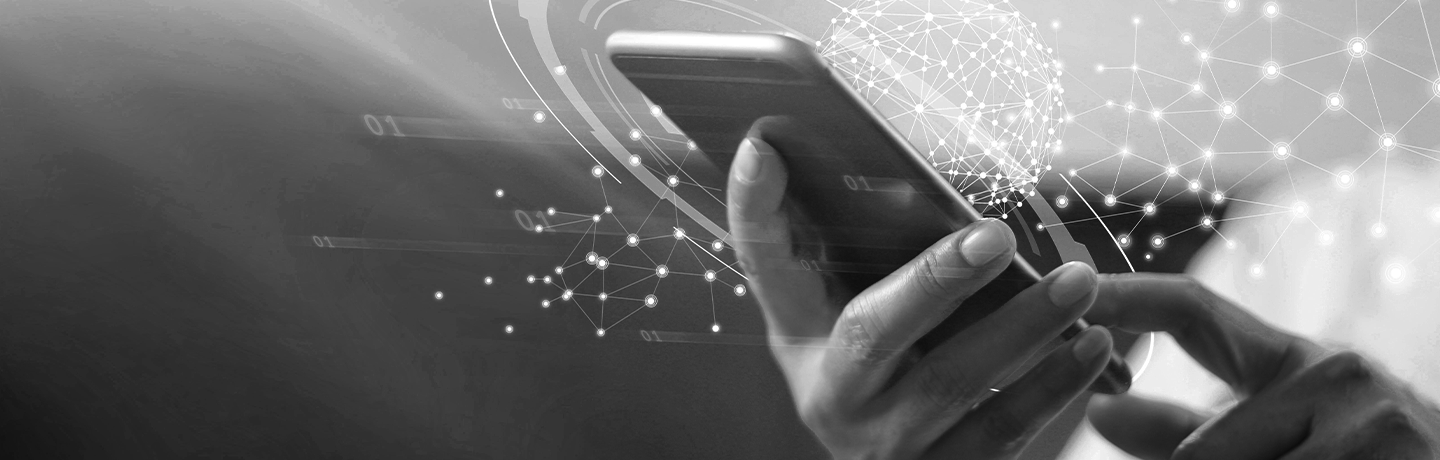 Black and white image of someone holding phone