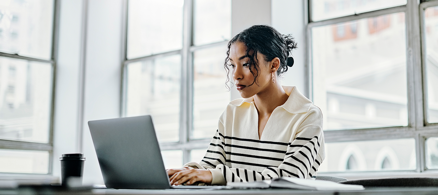 Woman concentrating on her laptop in the office
