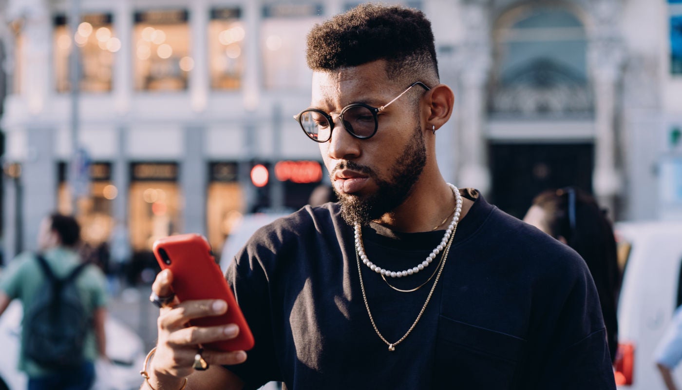 Man looking at his phone outside in the market